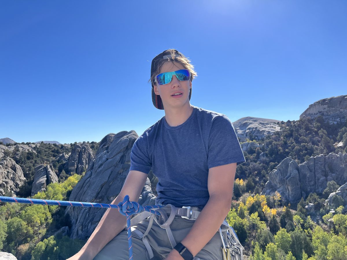 Carter at the top of a climb in the rocks