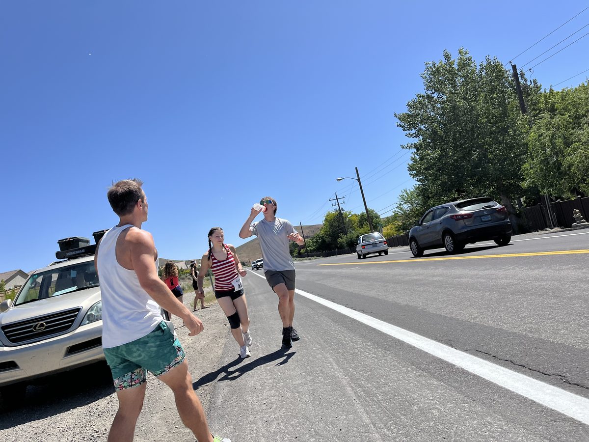 Carter grabbing water during a summer road race
