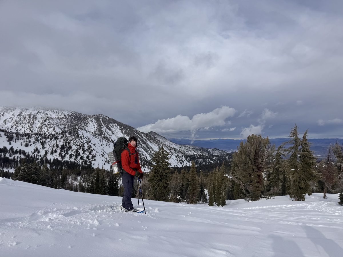 Carter ski touring on a snowy mountain ridge